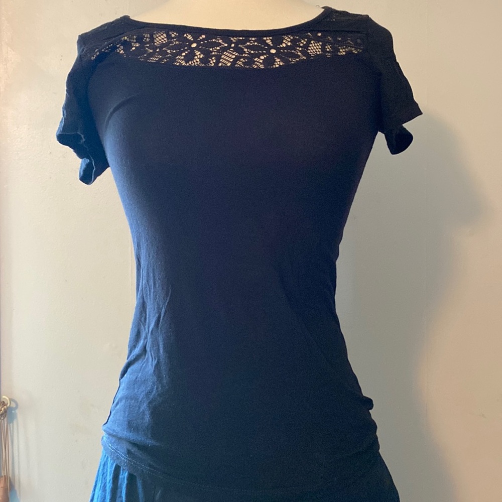 Black short sleeve tee with lace cut-out across chest and back. Like new